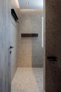 a shower with a glass door in a bathroom at HIGH END Unique 270 degree aerial sea view suite in Naxos Chora
