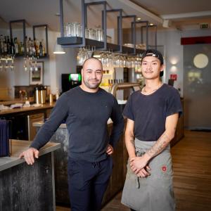 a man and a woman standing at a counter at Hotel & Restaurant Christian IV in Glückstadt