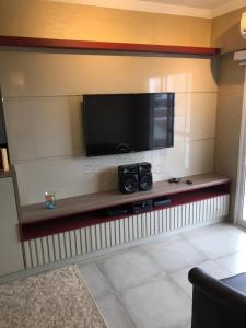 a flat screen tv on a wall in a living room at Apartamento todo mobiliado - Completo! in Sao Jose do Rio Preto +4 photos