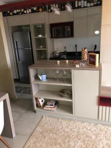 a kitchen with a counter and a refrigerator at Apartamento todo mobiliado - Completo! in Sao Jose do Rio Preto
