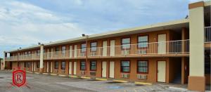 a building with a no parking sign in a parking lot at Royal Inn Greenville in Greenville