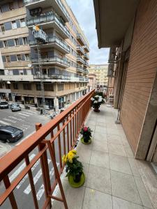 a balcony with flowers in pots on a building at Bartolo Health and Wellness in Cagliari