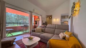 a living room with a couch and a table at Oasis of Aroeira Golf & Beach House in Aroeira