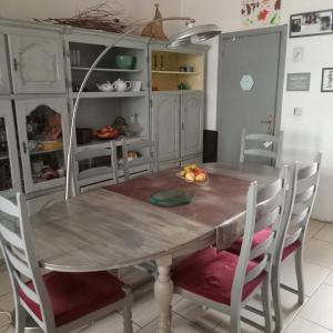 een eettafel en stoelen in een keuken bij Maison Bohème 