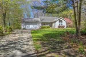 a house with a driveway in front of a yard at Bed & Birdie - New Vacation Rental - Close to golf course & downtown in Saugatuck
