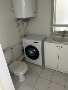 a small bathroom with a washing machine and a sink at Entre aubrac et rodez in Espalion