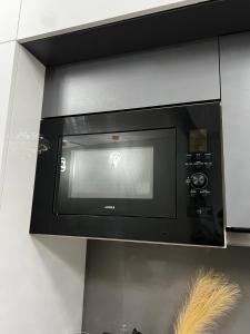 a microwave oven in a wall with at Luxury Heights with City View and River View in Noida
