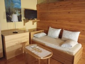 a room with a bed and a desk and a table at Rooms Roza in Slunj