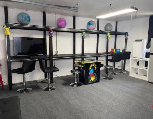 an office with a desk with chairs and a tv at Home in Anderson Township in Cincinnati