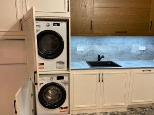 a kitchen with two washing machines and a sink at Apart house EMA 4 in Bansko