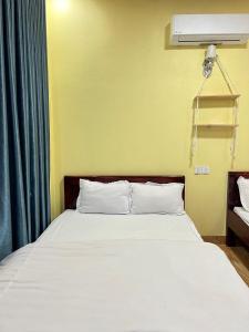 Giường trong phòng chung tại Homestay Bảo Nguyên Xanh
