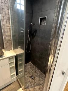 a shower with a glass door in a bathroom at Le Chalgrin in Paris