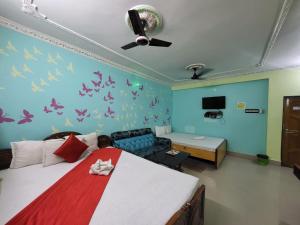 a bedroom with a bed and a couch at Abhishek Inn New Digha in Digha