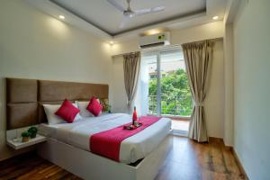 a bedroom with a bed with a candle on it at Luxury 2BHK Apartment By Bluewave Hospitality in Candolim