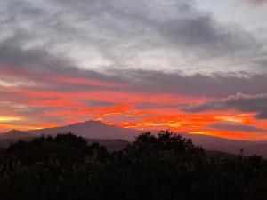 a sunset with a mountain in the background at Borgo Fastelli in Sarteano