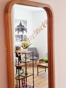 a mirror in a room with a table and a chair at Arboleda Centro in Soria