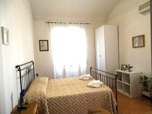 a bedroom with a bed and a large window at Rome artist house in Rome