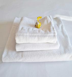 two white towels sitting on top of a table at Arboleda Centro in Soria