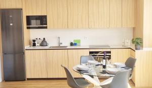 a kitchen with a table and chairs and a refrigerator at Arboleda Centro con Parking in Soria