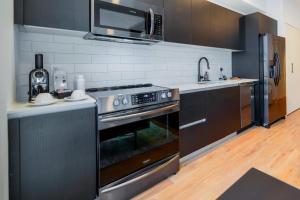 a kitchen with a stove and a microwave at Exquisite Bay View Studio at Downtown Miami in Miami