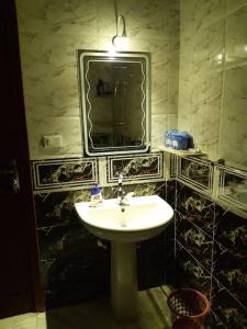 a bathroom with a sink and a mirror at Relaxing apartment overlooking the sea and 2 terrace on the sea in Quseir