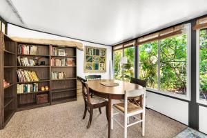 a dining room with a table and bookshelves at Jack's Place-Gulf Brz-Pool-Close to Bchs 2BD-1BT in Gulf Breeze