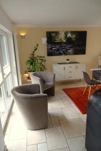 a living room with two chairs and a couch at Haus Ilsegarten in Ilsenburg