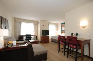 a hotel room with a bed and a living room at Residence Inn Rochester Mayo Clinic Area in Rochester