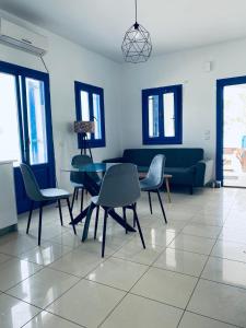 a living room with a table and chairs and a couch at Villa 33 in Monolithos