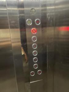a control panel of an elevator with red buttons at Convenient city apartment with free WiFi in Dar es Salaam