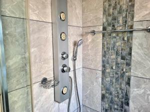 a shower with a glass door in a bathroom at Crystal Lagoon Lodge in Langebaan