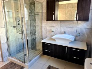 a bathroom with a sink and a shower at Crystal Lagoon Lodge in Langebaan