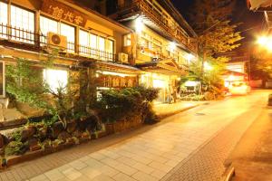 una calle de la ciudad por la noche con un edificio en Andaikan, en Yamanouchi