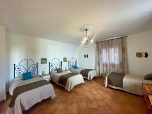 a room with three beds in a room at Villa Jardín in Priego de Córdoba +105 photos