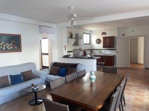 a living room with a table and a couch at Villa Jardín in Priego de Córdoba