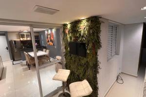a living room with a wall covered in plants at Apartamento Maravilhoso Perfeito in Sao Paulo