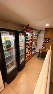 a store with two refrigerators in a grocery store at Apartamento Maravilhoso Perfeito in Sao Paulo