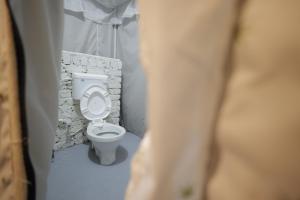a bathroom with a white toilet in a room at Ransuli mountain stay jungle camping in Dehradun +51 photos