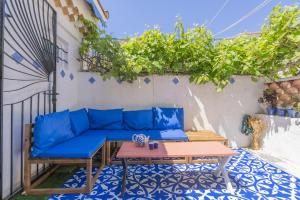 a blue couch on a patio with a table at Belle maison bleu azur in Six-Fours-les-Plages