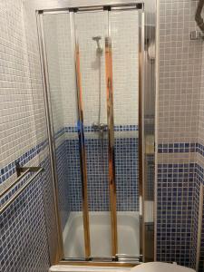 a bathroom with a shower and a toilet and a tub at Apartamento Puerta del Perdón in Constantina +14 photos