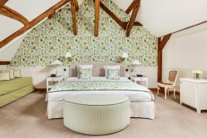 a bedroom with a large bed and a table at Les Hauts de Loire in Onzain