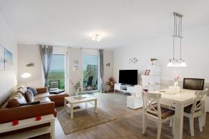 a living room with a couch and a table at Opashus in Borkum