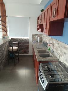 a kitchen with a stove and a counter top at Confortable apartamento in Rivas
