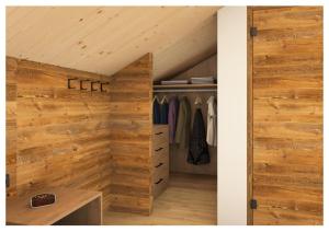 Cette chambre mansardée dispose de murs en bois et d'un placard. dans l'établissement Rodererhof, à Laion