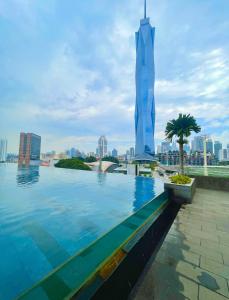 a swimming pool with a view of the burj khalifa at Opus Residences Kuala Lumpur by Luna in Kuala Lumpur