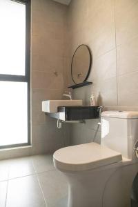 a bathroom with a white toilet and a mirror at Mickey's Magic Urban Suites Jelutong Penang, Seaview in Jelutong