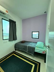 a small bedroom with a bed and a window at Sirami homestay in Kampar +13 photos