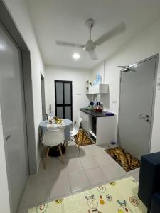 a room with a desk and a table and chairs at Sirami homestay in Kampar