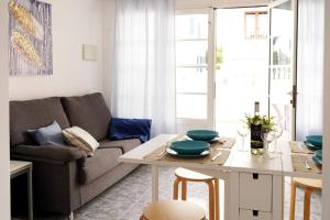 a living room with a couch and a table at Apartamento Maresía in Arrieta