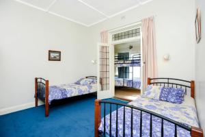 a bedroom with two beds and a window at Beachfront Bliss - Wi-fi Bbq Group House in Victor Harbor